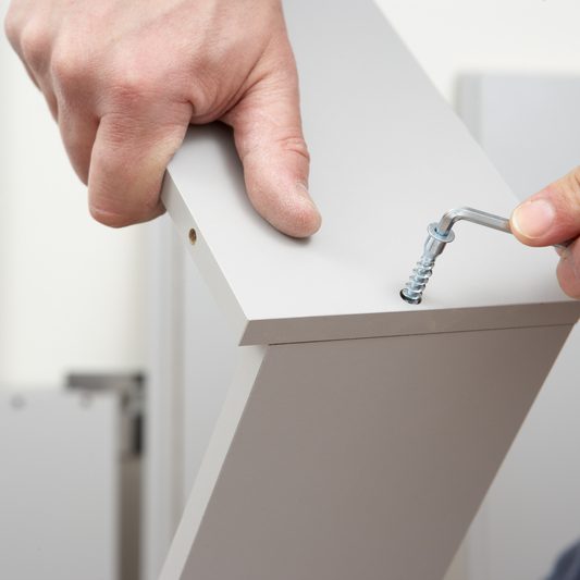 Man putting together IKEA furniture